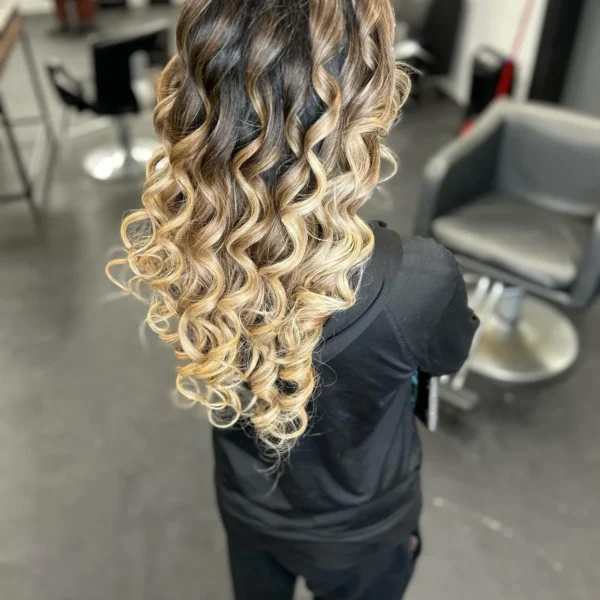 Long ombre curls fading from dark brown to blonde, finished in the salon at Chair'istry Salon in Wichita