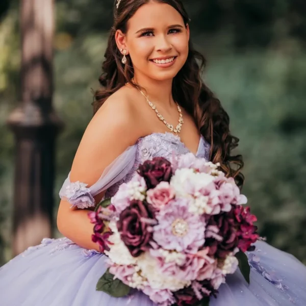 Quinceañera in a lavender gown with a tiara and long dark curls, hair styled by Chair'istry Salon in Wichita